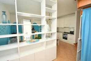 A kitchen with white cabinets, a microwave, and a stove. - Residenz Arcobaleno, "Granchio" Three-Room Apartment for 6 People (Chioggia)