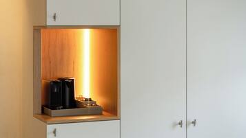 A cabinet with a built-in coffee machine and a shelf.