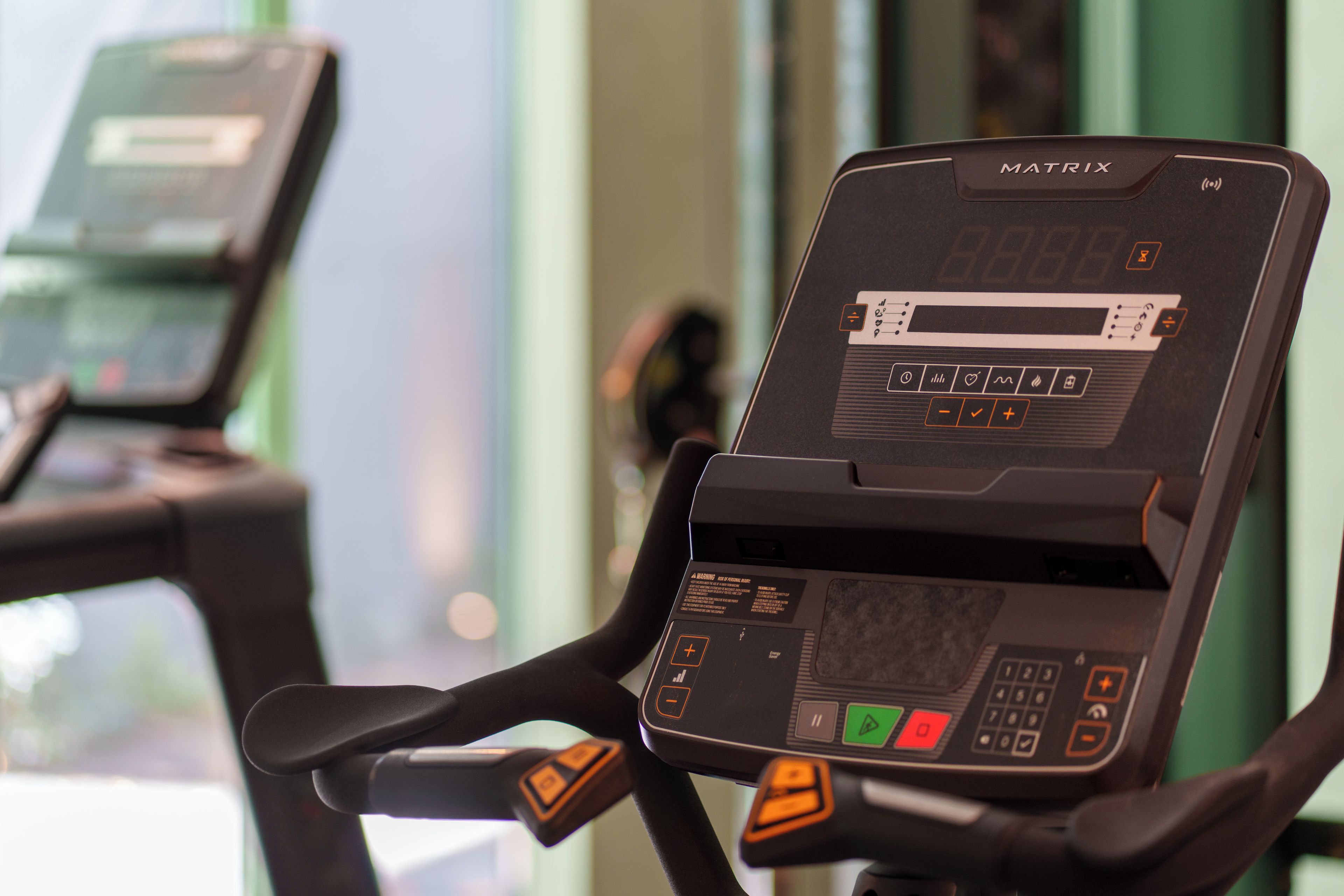A stationary exercise bike with a digital display and control panel.
