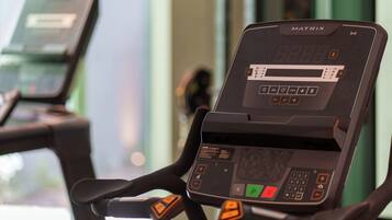 A stationary exercise bike with a digital display and control panel.
