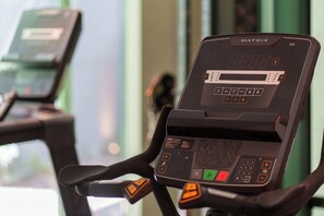 A stationary exercise bike with a digital display and control panel.
