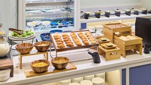 A buffet setup with various food items and serving utensils. - Holiday Inn Express Sapporo Susukino by IHG (Sapporo)