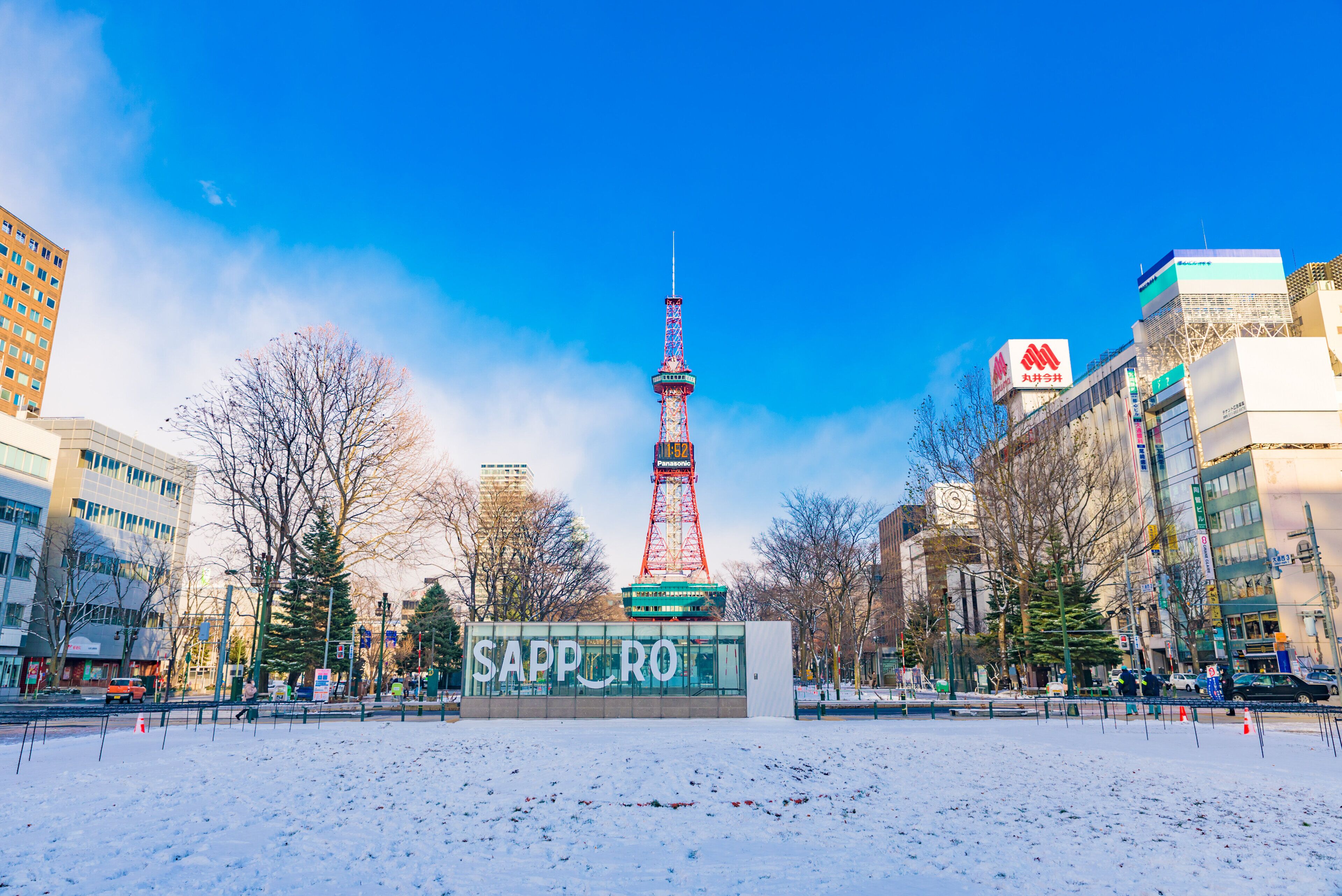 A snowy urban scene with a prominent tower and a building labeled 'SAPPORO'.