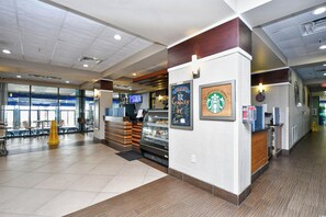 A Starbucks coffee shop interior with a counter, seating area, and large windows. - 2BR Oceanfront Full Kitchen free Waterprk sleeps 7 (Myrtle Beach)