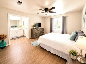 A bedroom with a bed, a TV on a dresser, a ceiling fan, and a window with curtains. - Military-Friendly 3BR 2 BA Schertz Retreat Near Randolph AFB Sleeps 8 (Schertz)