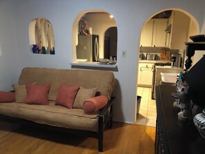 A living room with a sofa, kitchen area with appliances, and a dining table. - Casa de Monte Vista, balcony, patios, 3/3, 2 kit, 3 lvg areas, walk to Canyon Rd (Santa Fe)