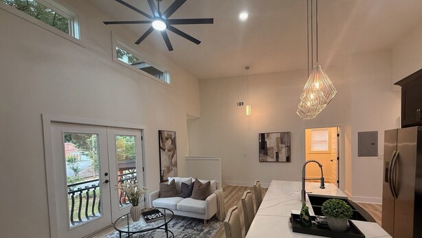 A modern kitchen with a dining area, a ceiling fan, and a view of the outdoors. - Sweet Atlanta Escape (Atlanta)