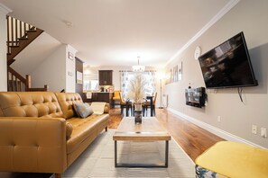 Ein Wohnzimmer mit Sofa, Couchtisch und Fernseher.