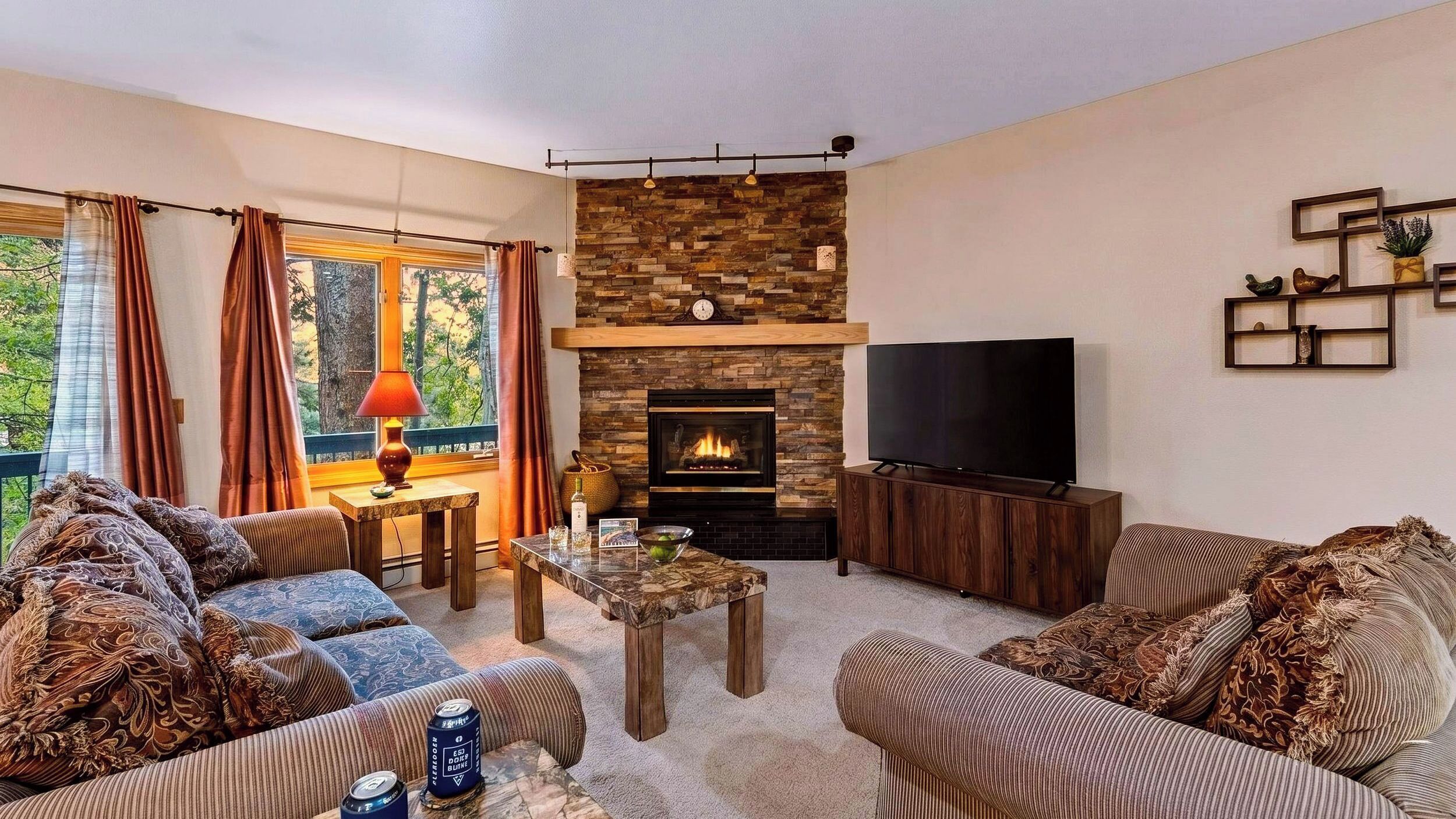 A living room with a fireplace, a television, and a sofa.
