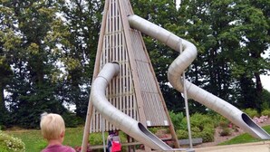 A playground with a slide and climbing structure.