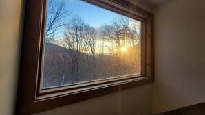A skylight window with a view of trees and a clear sky. - Cozy Retreat in Waterville Estates! RR194E (Campton)