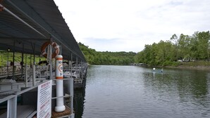 A dock with a covered seating area, a lifebuoy, and a sign with instructions. - Relaxing Resort Condo for 6 guests, In The Heart of Beautiful Branson! (Branson)