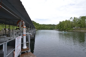A dock with a covered seating area, a lifebuoy, and a sign with instructions. - Relaxing Resort Condo for 6 guests, In The Heart of Beautiful Branson! (Branson)
