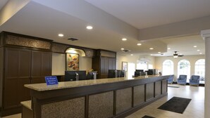 A reception area with a counter, seating, and a 'No Weapons Allowed' sign. - Relaxing Resort Condo for 6 guests, In The Heart of Beautiful Branson! (Branson)