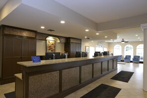 A reception area with a counter, seating, and a 'No Weapons Allowed' sign. - Relaxing Resort Condo for 6 guests, In The Heart of Beautiful Branson! (Branson)