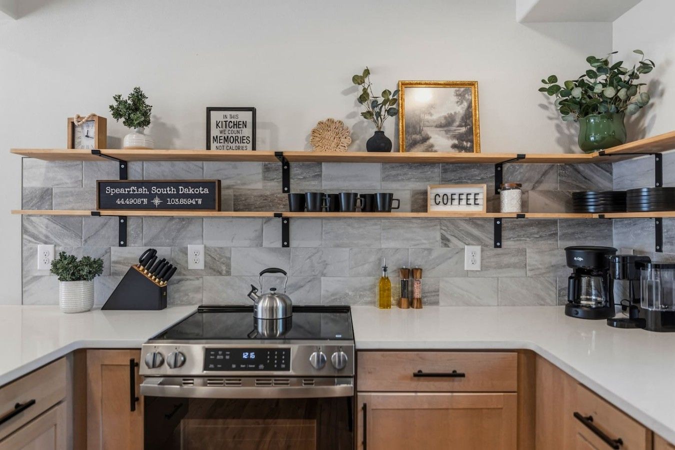 A kitchen with a stove, coffee maker, and a sign indicating the location as Spearfish, South Dakota.