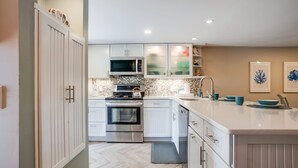 A modern kitchen with white cabinets, a stainless steel oven, a microwave, and a large island with a sink. - Oceanfront Complex - New Rental
- Steps to Beach/Pool/Coligny 
- Sleeps 6pp (Hilton Head Island)