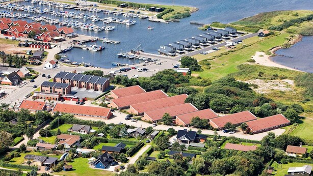 An aerial view of a coastal town with a marina, residential buildings, and a beach. - 4 Person Holiday Park Home in Hemmet (Hemmet)