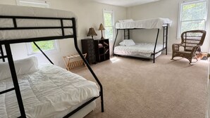 A bedroom with bunk beds, a rocking chair, a lamp, and a small wooden shelf. - Private Garden Estate, Jacuzzi, Cinema & Games (Southborough)