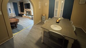 A dining area with a wooden table, chairs, a small rug, and a candle on the table. - Large, comfortable home, great location, 4 bedroom, washer/dryer, pet friendly (Mobile)
