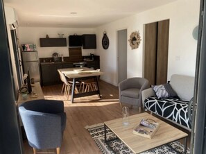 Ett modernt vardagsrum med en matplats, en soffa och ett soffbord.