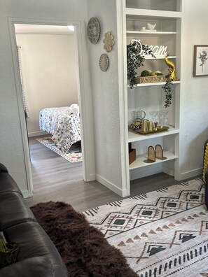 A room with a bed, a white wardrobe, a patterned rug, and a brown furry rug. - Rood Roost: Spacious 3BR Near Downtown & Grand Junction Adventures (Grand Junction)