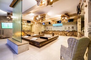 A spa area with massage tables, a reception desk, and a large mirror. - Camping 4 étoiles - Parc aquatique - ccbfiab (Agde)