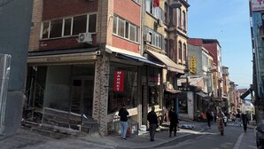 A multi-story building with a market sign, a staircase, and a storefront labeled 'NICOLETTA.' - Valeria Homes Sultanahmet (fatih)