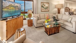 A living room with a television, sofa, coffee table, and decorative items. - Kaanapali Alii-2 Bedroom Partial Ocean Views (Lahaina)