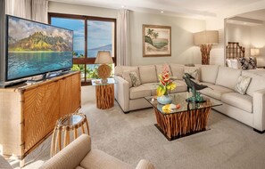 A living room with a television, sofa, coffee table, and decorative items. - Kaanapali Alii-2 Bedroom Partial Ocean Views (Lahaina)