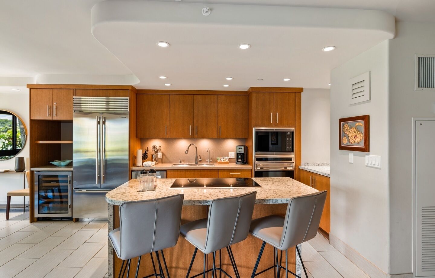 A modern kitchen with wooden cabinets, stainless steel appliances, and a granite countertop.