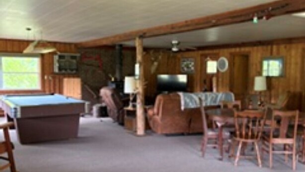 A room with a pool table, a sofa, and a dining table with chairs. - Peaceful 2-bedroom cabin with AC in welcoming Villa Ridge (Villa Ridge)