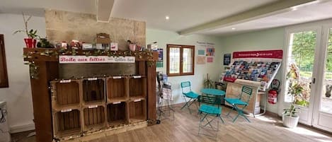 A reception area with a wooden desk, a bulletin board, and a seating area with chairs.