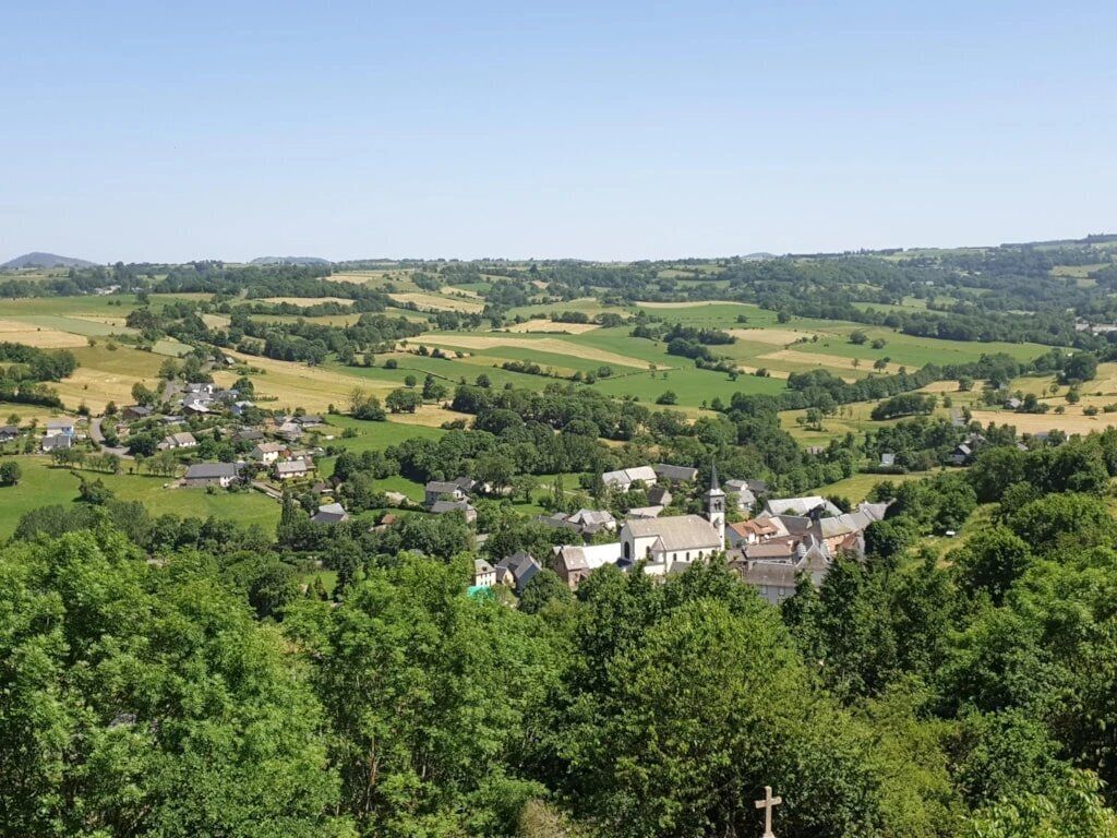 A rural landscape with a village, houses, and a church.