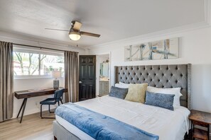 A bedroom with a bed, a desk, a chair, a ceiling fan, and a painting on the wall. - Pet-Friendly Scottsdale Retreat w/ Pool & Hot Tub (Scottsdale)