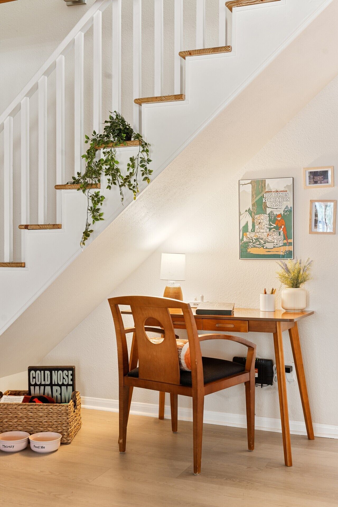 A staircase with white railings and a wooden handrail.