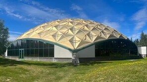 A geodesic dome structure with a curved entrance and large windows. - Peaceful 5-bedroom Lakehouse in charming Kenai perfect for families (Kenai)