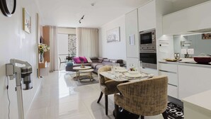 A modern apartment with a dining area, kitchen, and living space. - The Signature Luxury Stay (Midrand)