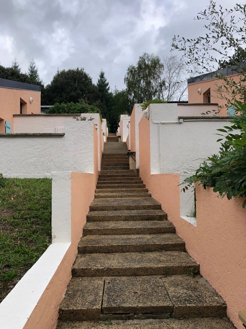 A staircase leading to a row of buildings with a uniform exterior.