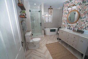 Une salle de bain avec une douche Ă parois de verre, des toilettes, une baignoire et un meuble-lavabo avec des tiroirs.