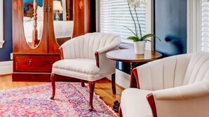 A room with a wooden armoire, two white armchairs, a small round table, and a potted plant. - The George & Martha Room @ Portland's White House Bed & Breakfast (Portland)