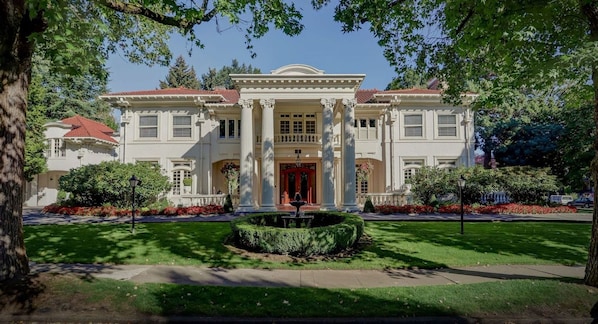 A stately building with a symmetrical facade, large windows, and a central entrance.
