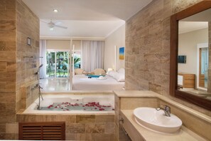 A modern bathroom with a bathtub, a sink, and a shower area. - Beautiful 1-bdrm suite steps from the beach in Puerto Plata with deck and AC (Puerto Plata)