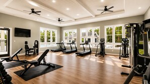 A gym with treadmills, weight machines, and a TV on the wall. - King Bed + Saltwater Pool, 8 Min to Airport (Jacksonville)