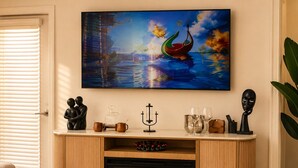 A living room with a fireplace, a painting, and a coffee table with decorative items. - King Bed + Saltwater Pool, 8 Min to Airport (Jacksonville)