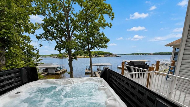 A hot tub with a view of a lake and dock. - It's A Shore Thing - Boat Slips and Hot Tub (Osage Beach)