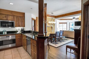 A modern kitchen with wooden cabinets, stainless steel appliances, and a central island. - Upscale PH @Austria Haus in Vail Village on Bridge Rd, 3 min walk to Gondola 1 (Vail)