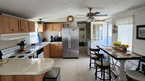A kitchen with wooden cabinets, a stainless steel refrigerator, a dining table with chairs, and a ceiling fan. - Serene two bedroom mobile home with AC in Murphy, ID.
Outdoor recreation galore! (Murphy)