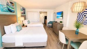 A hotel room with a bed, bedside tables, a desk, and chairs. - Charming Oceanfront Studio for 4! Pinnacle 1163 (Myrtle Beach)