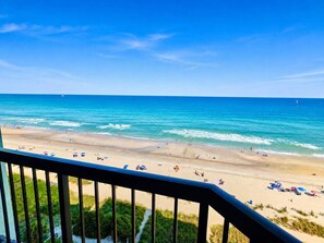 A beach with clear skies, a sandy shore, and a railing in the foreground. - Charming Oceanfront Studio for 4! Pinnacle 1163 (Myrtle Beach)
